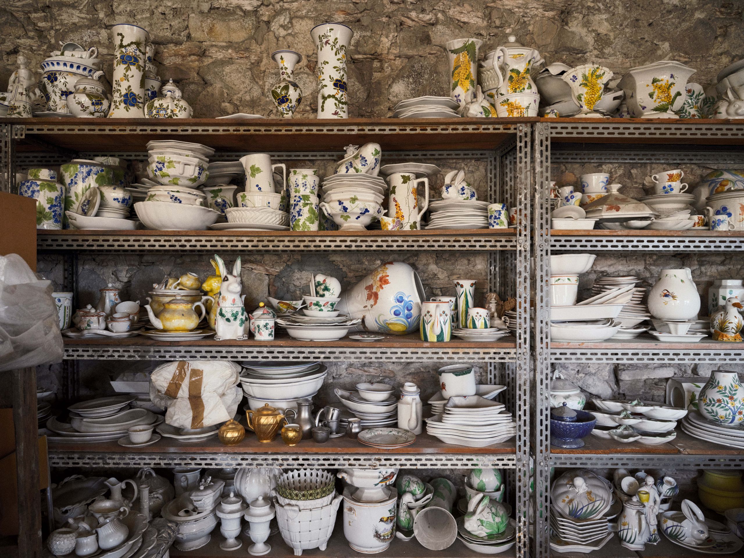 Image may contain Art Porcelain Pottery Shelf Furniture Cabinet Cup Accessories Bag Handbag Plate and Person